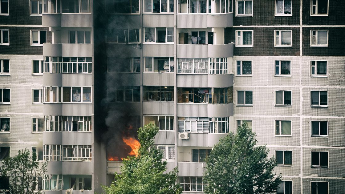 Fire with black smoke in multistory apartment building