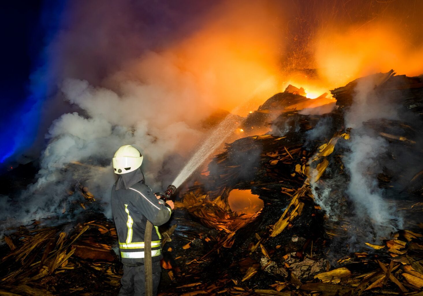 A Fire Damaged Site With Water Sprinkles